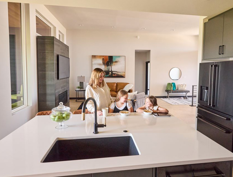 Women and children laughing in kitchen